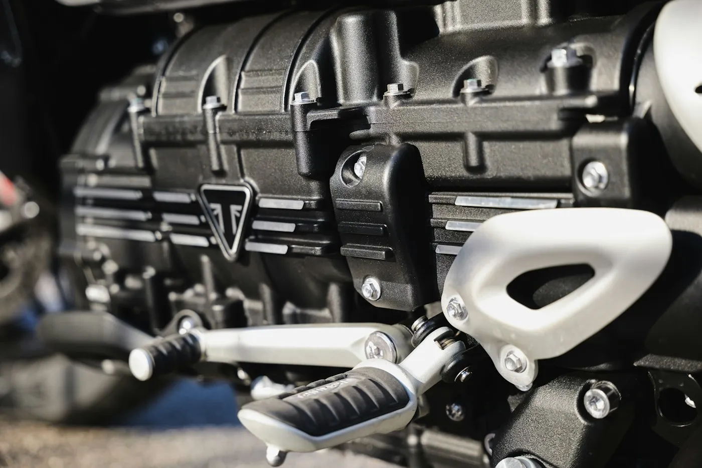 Shiny engine component covered in oil droplets