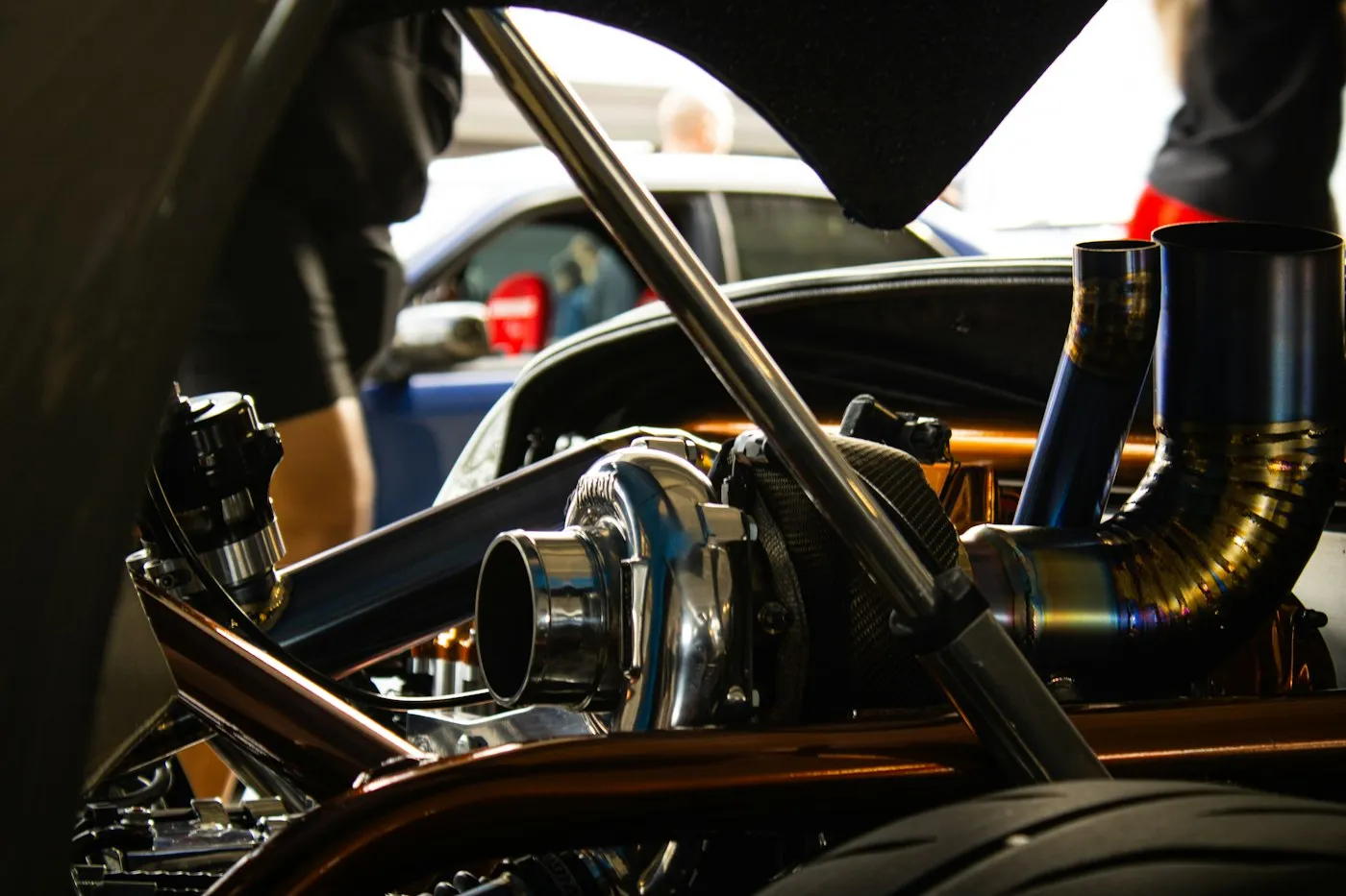 Mechanic pouring oil into an engine compartment