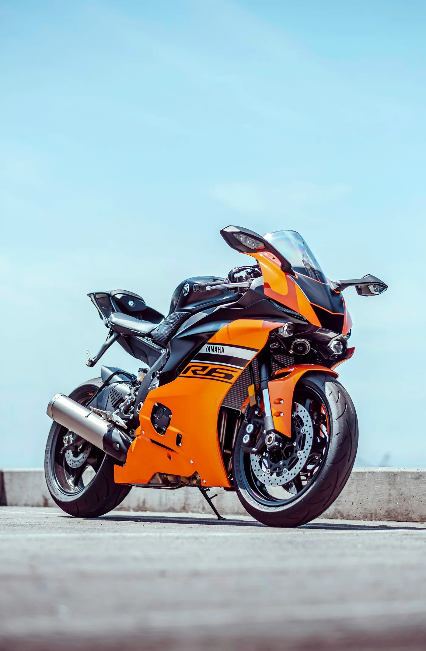 Orange and black sports motorcycle parked